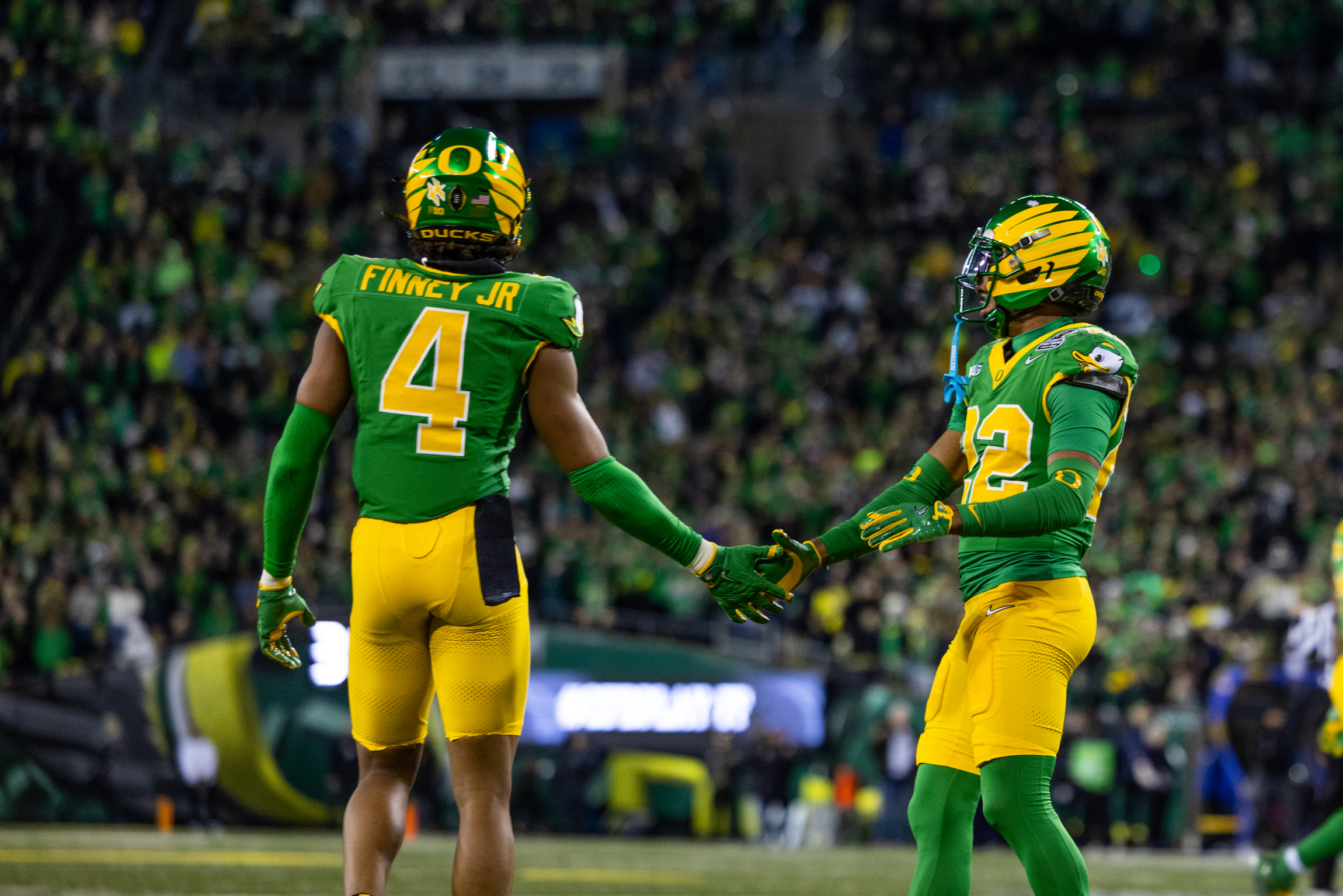 Brandon Finney Jr. #4 celebrates with teammate at Autzen Stadium