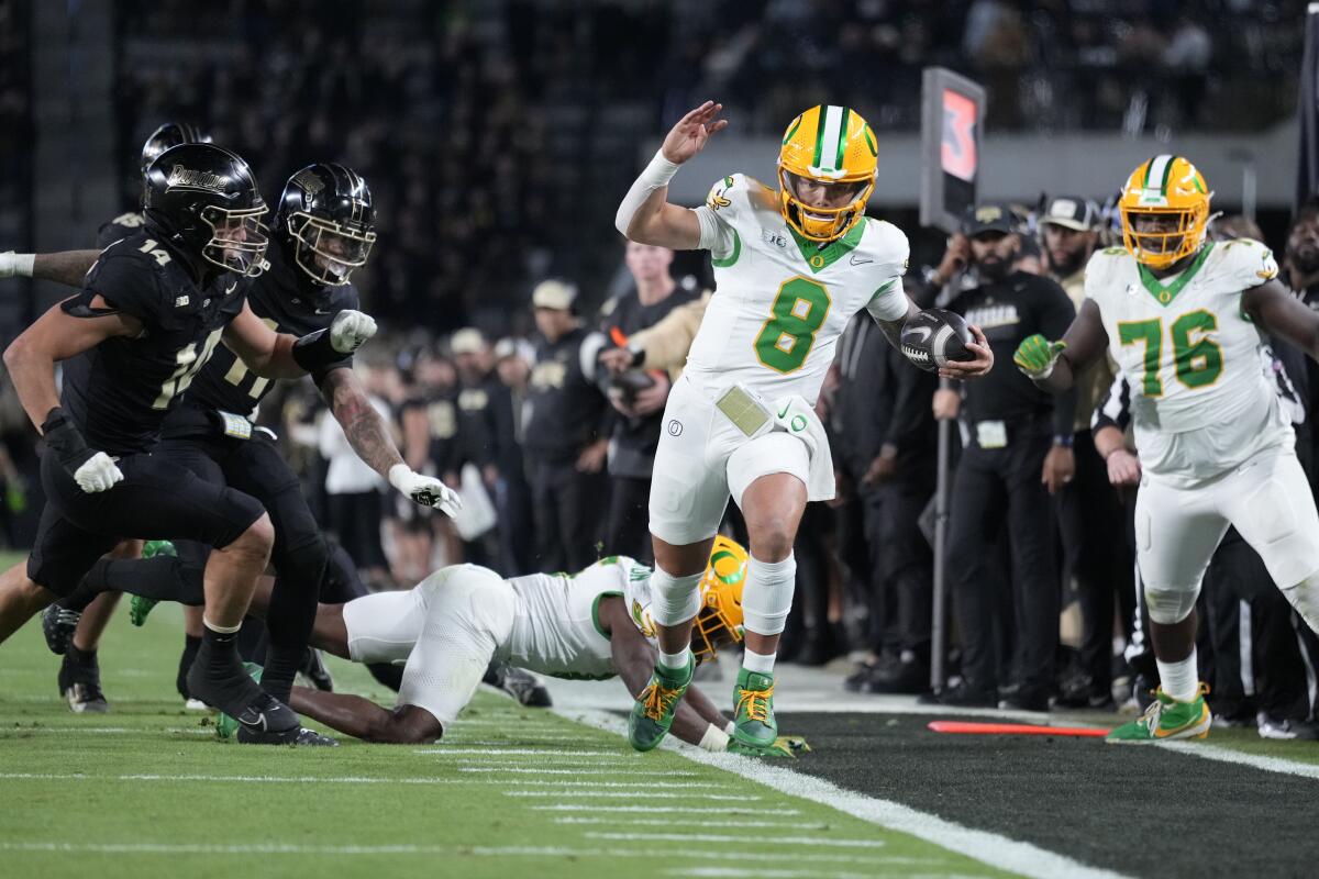 Dillon Gabriel #8 scrambles against Purdue in Oregon's first Big Ten road win, 2024