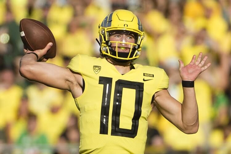 Justin Herbert #10 in Oregon all-yellow uniform at Autzen Stadium