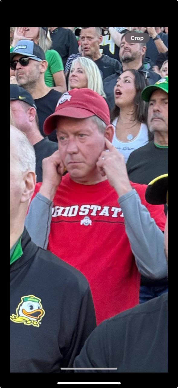An Ohio State fan covers his ears at Autzen Stadium during the 2024 Oregon-Ohio State game